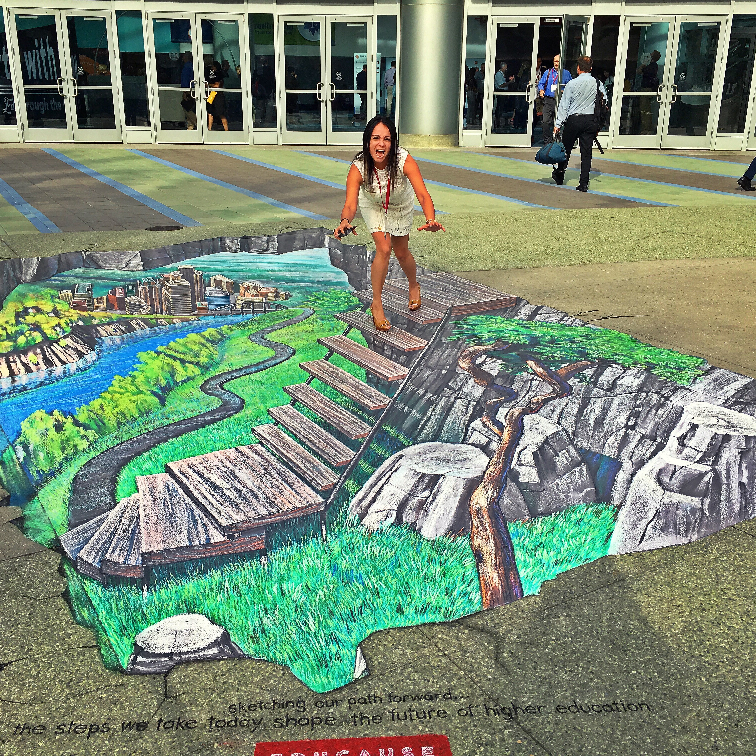 Georgetown University's Head of Library IT Services has fun with EDUCAUSE sidewalk art.