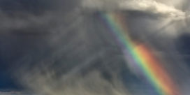 a rainbow and storm showing deconstruction