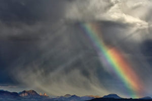 a rainbow and storm showing deconstruction