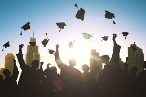 college graduation caps soaring in the sky