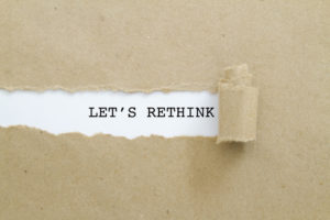 Torn paper revealing the words "let's rethink" as schools try to empower students