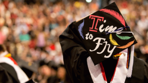 "Time to fly" written on a graduation cap
