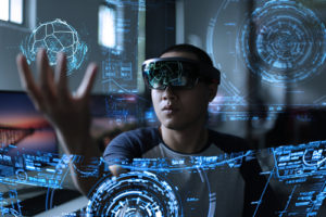 A futuristic image of a student playing with a hologram