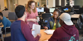 Meghan Roddy chats with a group of her college students