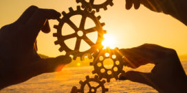 A group of different-sized gears working together to symbolize a partnership