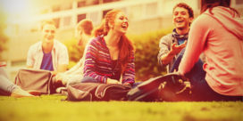 a group of college freshmen hanging outside and laughing