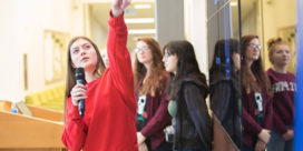 A girl with a microphone leading a group of others