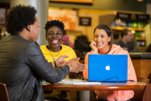 A group of college students working on laptops