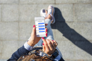 a girl walking with an app pulled up to give her directions