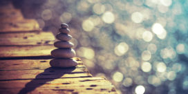 a calming photo of a stack of rocks and water