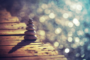 a calming photo of a stack of rocks and water