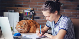 A woman works at home as she is pursuing higher education.