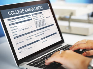 Chief enrollment officers shoulder much responsibility, but their role is increasingly complicated, as shown by this concept of online enrollment on a laptop.