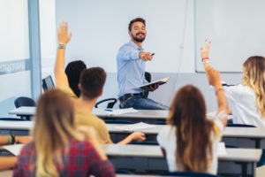 A strategy known as student segmentation could help campuses better serve diverse the students of tomorrow, like these students raising their hands in a lecture.